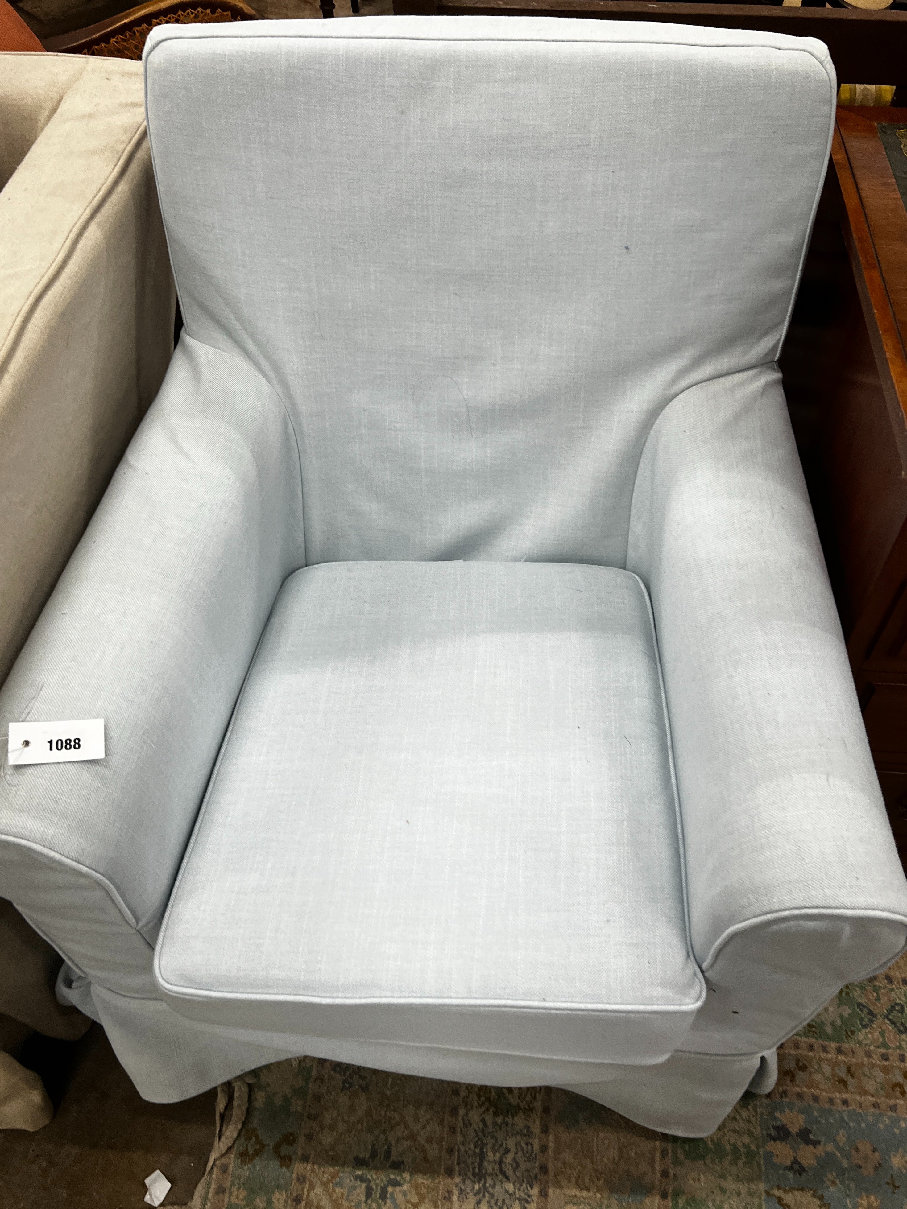 A Laura Ashley armchair upholstered in a pale blue fabric, length 76cm, depth 65cm, height 86cm